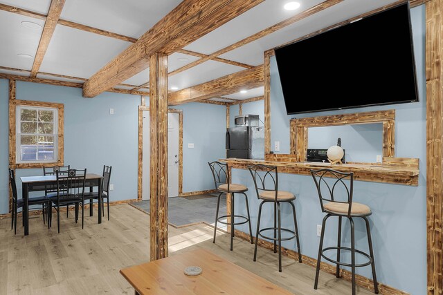 23748 Cutler Rd, Newaygo, MI 49337 - kitchen featuring light wood-type flooring, freestanding refrigerator, baseboards, coffered ceiling, and a kitchen breakfast bar