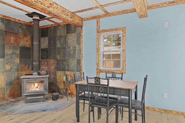 23748 Cutler Rd, Newaygo, MI 49337 - dining area with a wood stove, wood finished floors, and baseboards