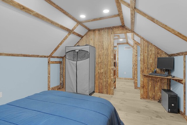23748 Cutler Rd, Newaygo, MI 49337 - bedroom with vaulted ceiling, light wood-style flooring, and wooden walls