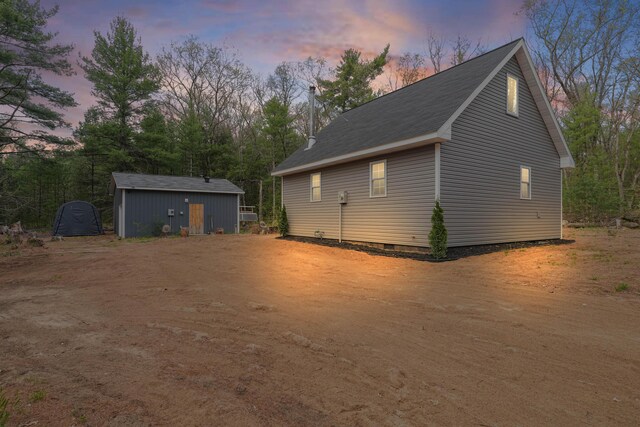 23748 Cutler Rd, Newaygo, MI 49337 - property exterior at dusk with crawl space and an outbuilding