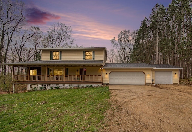 23127 Kendaville Rd, Pierson, MI 49339 - farmhouse inspired home with driveway, a porch, a lawn, and a garage