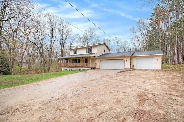 23127 Kendaville Rd, Pierson, MI 49339 - view of front of property with covered porch, dirt driveway, and an attached garage