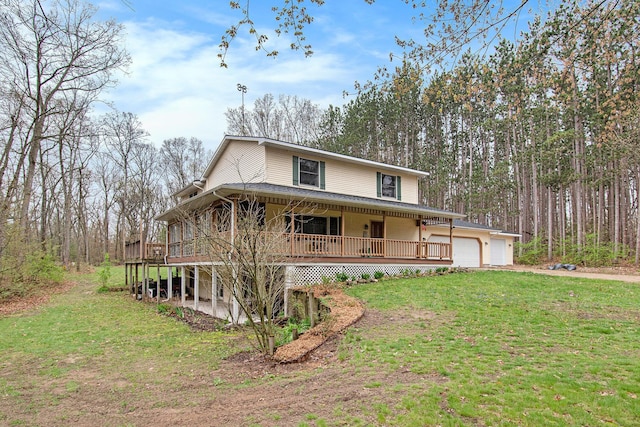23127 Kendaville Rd, Pierson, MI 49339 - farmhouse inspired home featuring a front lawn, a garage, driveway, and a porch