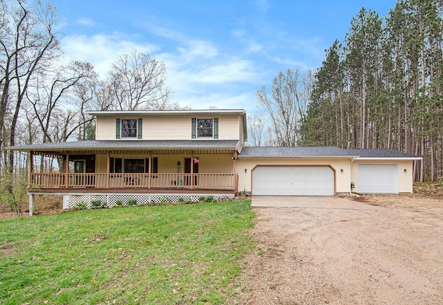 23127 Kendaville Rd, Pierson, MI 49339 - country-style home featuring driveway, a porch, a front yard, a garage, and roof with shingles