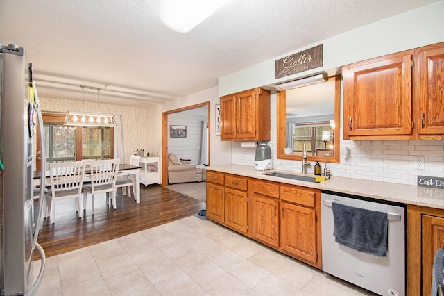 23127 Kendaville Rd, Pierson, MI 49339 - kitchen with dishwasher, a sink, healthy amount of natural light, and tasteful backsplash