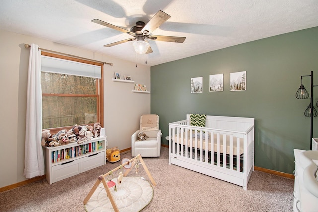 23127 Kendaville Rd, Pierson, MI 49339 - bedroom featuring carpet floors, a nursery area, baseboards, and ceiling fan
