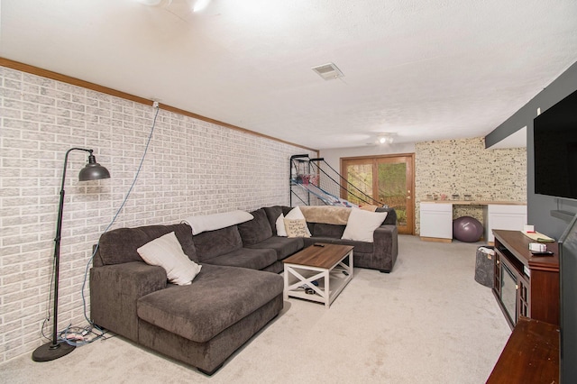 23127 Kendaville Rd, Pierson, MI 49339 - carpeted living area with brick wall and stairway