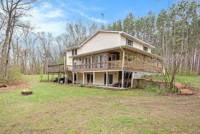 23127 Kendaville Rd, Pierson, MI 49339 - rear view of property featuring a fire pit, a deck, a sunroom, a yard, and a patio