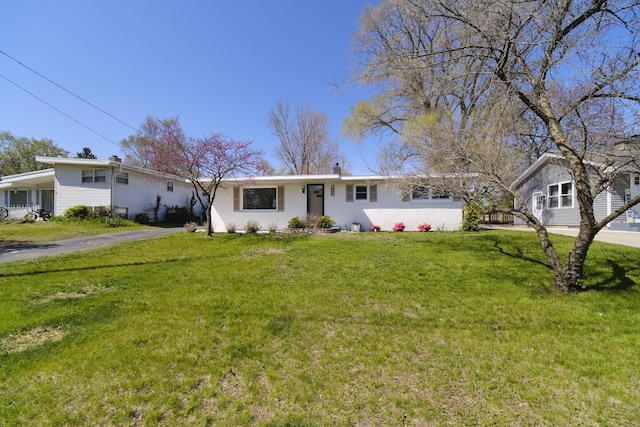 923 Maple St, Ludington, MI 49431 - ranch-style home with a front yard and asphalt driveway