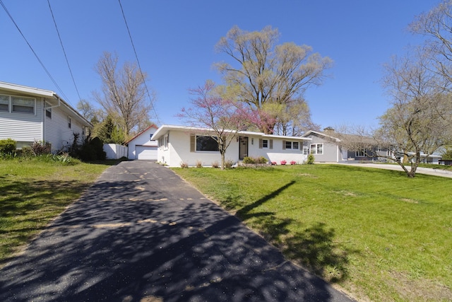 923 Maple St, Ludington, MI 49431 - view of front of home featuring asphalt driveway and a front lawn