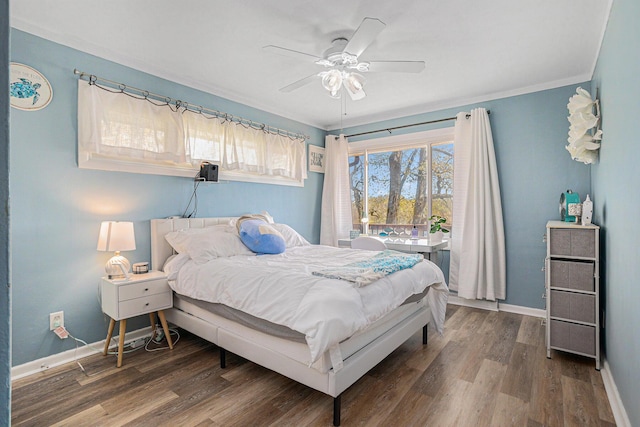 bedroom with wood finished floors, baseboards, crown molding, and ceiling fan