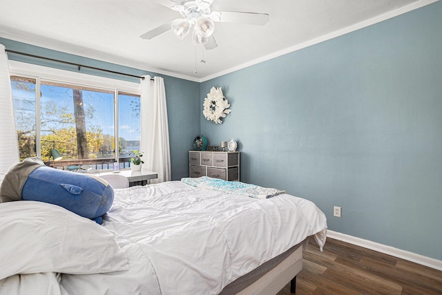 bedroom featuring dark wood finished floors, baseboards, ornamental molding, and ceiling fan