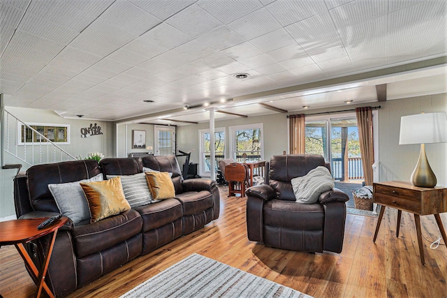 living area featuring hardwood / wood-style flooring and a ceiling fan