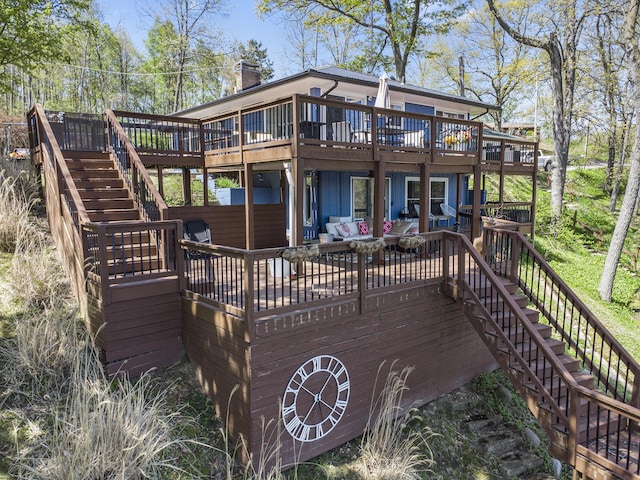 deck featuring stairs, a patio, and an outdoor living space