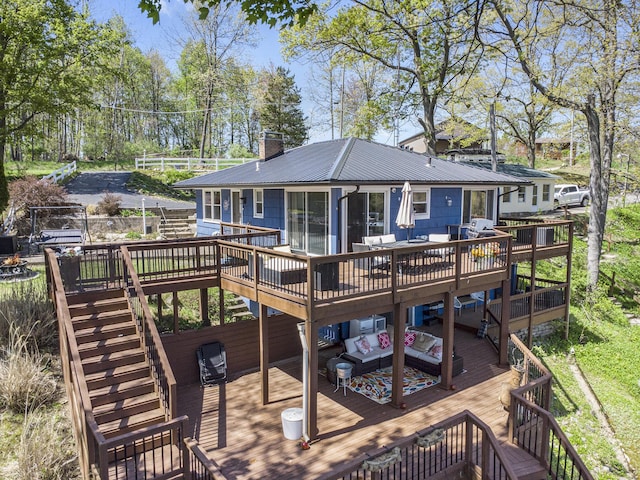 rear view of house featuring stairs, an outdoor living space, and a wooden deck