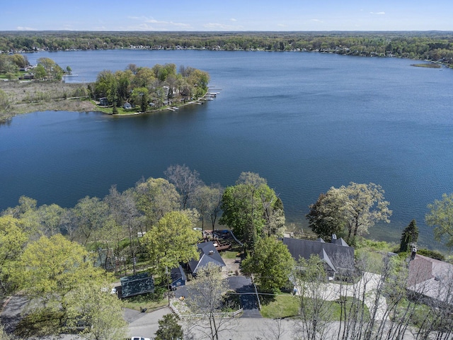 aerial view of property and surrounding area featuring a nearby body of water