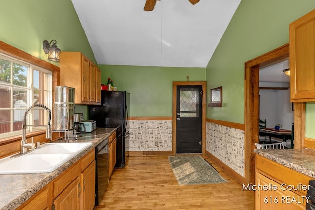626 Academy St, Portland, MI 48875 - kitchen with lofted ceiling, black appliances, light wood-type flooring, wainscoting, and a ceiling fan