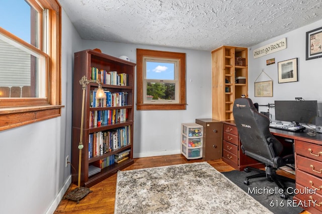 626 Academy St, Portland, MI 48875 - office area featuring dark wood-style flooring and a textured ceiling