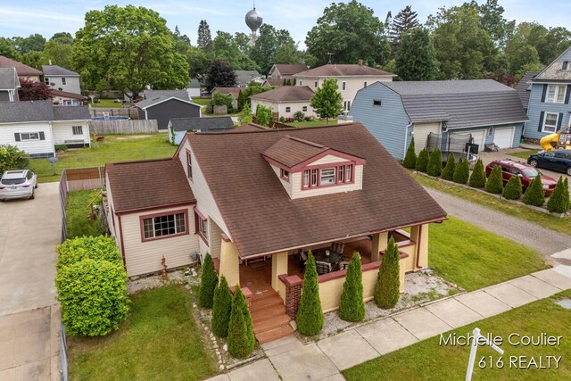 626 Academy St, Portland, MI 48875 - view of front of home with a porch, a residential view, and a front lawn