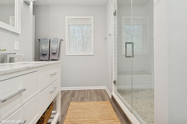 6490 E Chikaming, Sawyer, MI 49125 - bathroom featuring a stall shower, wood finished floors, vanity, and baseboards