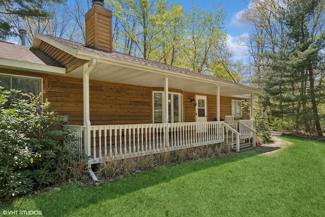 6490 E Chikaming, Sawyer, MI 49125 - view of front of home with a chimney, a porch, a front lawn, and a shingled roof
