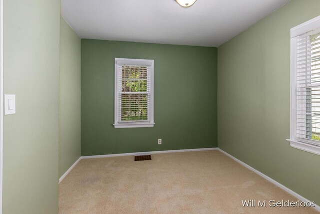 carpeted spare room with baseboards