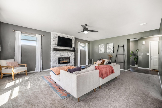 5790 Paxton Ct, Portage, MI 49024 - living room with carpet flooring, ceiling fan, baseboards, and a stone fireplace