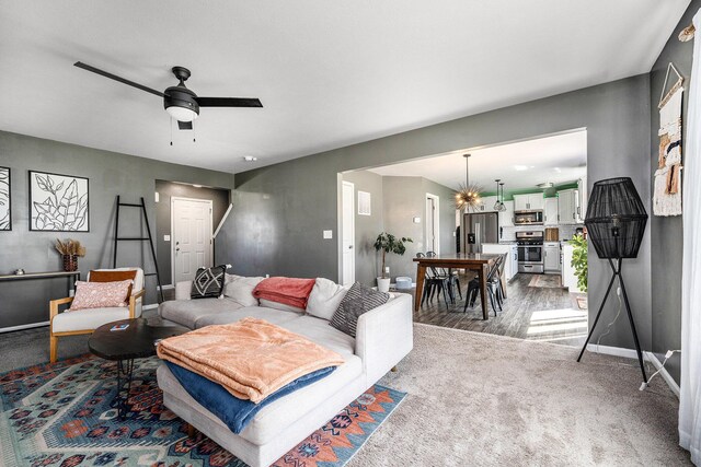 5790 Paxton Ct, Portage, MI 49024 - living room with baseboards, ceiling fan, a chandelier, and carpet