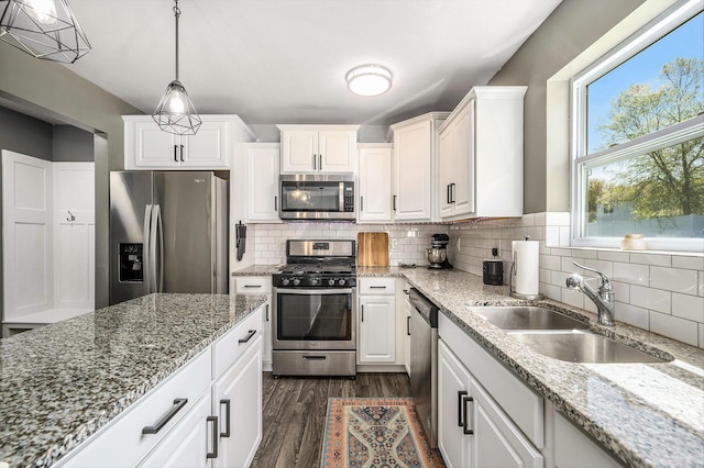 5790 Paxton Ct, Portage, MI 49024 - kitchen with appliances with stainless steel finishes, a sink, white cabinets, dark wood-style floors, and backsplash