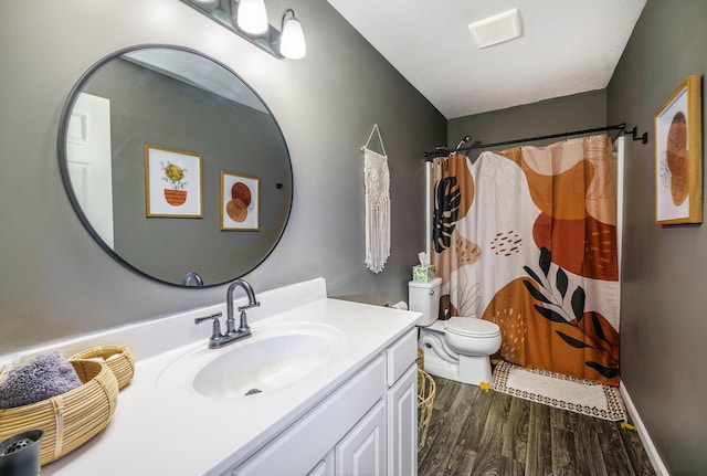 5790 Paxton Ct, Portage, MI 49024 - bathroom featuring wood finished floors, vanity, toilet, and curtained shower