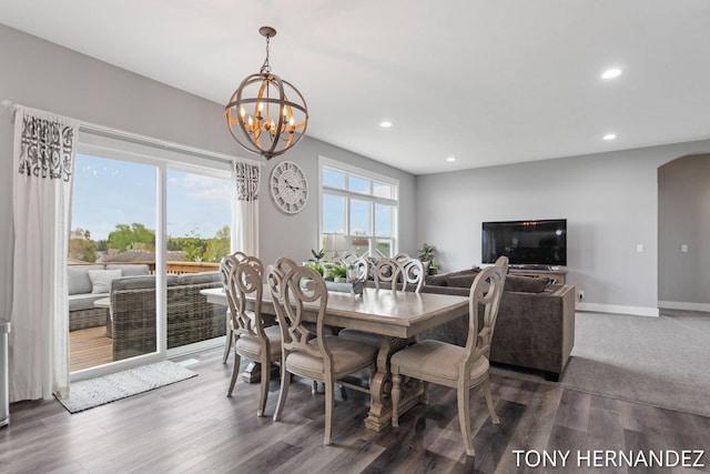 7104 Crimson Ct, Hudsonville, MI 49426 - dining area featuring recessed lighting, a chandelier, arched walkways, wood finished floors, and baseboards