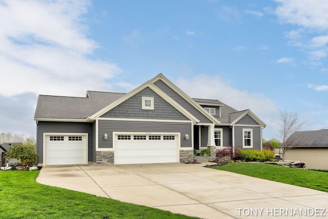 7104 Crimson Ct, Hudsonville, MI 49426 - craftsman-style home featuring concrete driveway, an attached garage, stone siding, and a front yard