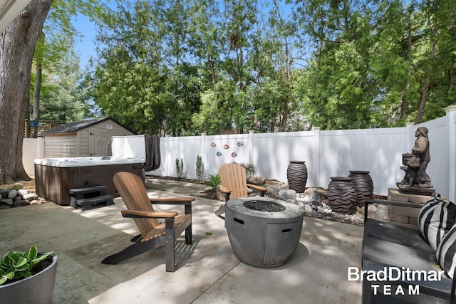 2151 Anderson Dr SE, Grand Rapids, MI 49506 - view of patio with a hot tub, a fire pit, a fenced backyard, and a storage shed