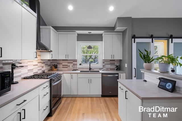 2151 Anderson Dr SE, Grand Rapids, MI 49506 - kitchen with appliances with stainless steel finishes, a sink, backsplash, light wood-type flooring, and recessed lighting