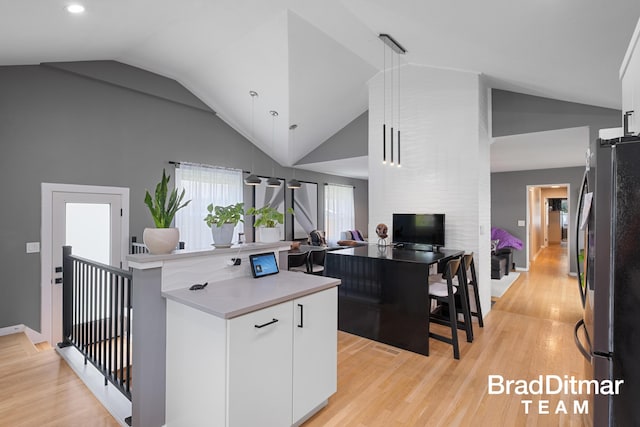 2151 Anderson Dr SE, Grand Rapids, MI 49506 - kitchen featuring freestanding refrigerator, white cabinetry, light wood-type flooring, light countertops, and recessed lighting