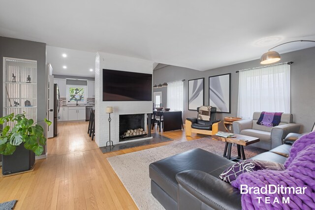 2151 Anderson Dr SE, Grand Rapids, MI 49506 - living room featuring light wood-style flooring, a large fireplace, and recessed lighting