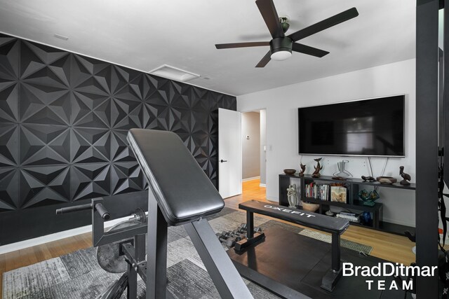 2151 Anderson Dr SE, Grand Rapids, MI 49506 - exercise room featuring an accent wall, a ceiling fan, wood finished floors, and baseboards
