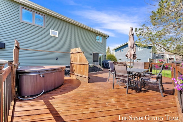 17083 Spahr St, Spring Lake, MI 49456 - wooden deck with a hot tub and outdoor dining area