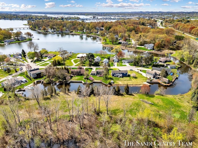 17083 Spahr St, Spring Lake, MI 49456 - aerial overview of property's location featuring a large body of water, nearby suburban area, and a tree filled landscape