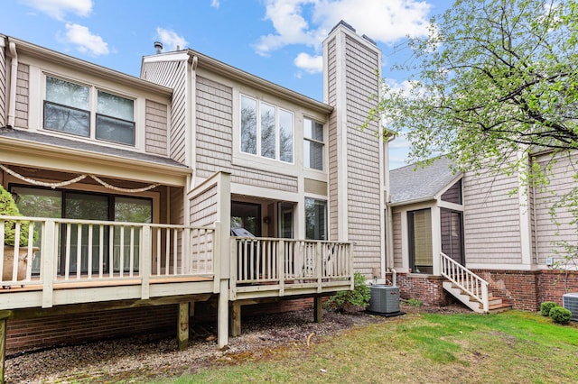 2485 Wildbrook Run Unit 154, Bloomfield Hills, MI 48304 - rear view of property featuring a wooden deck, a chimney, and central AC