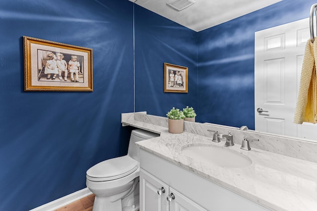 2485 Wildbrook Run Unit 154, Bloomfield Hills, MI 48304 - half bathroom with toilet, vanity, baseboards, and wood finished floors