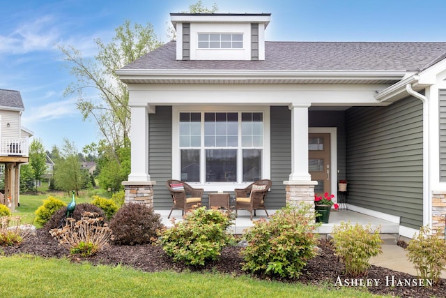 4700 Albright Ct SW Unit 6, Wyoming, MI 49418 - back of house featuring a porch, a shingled roof, and stone siding