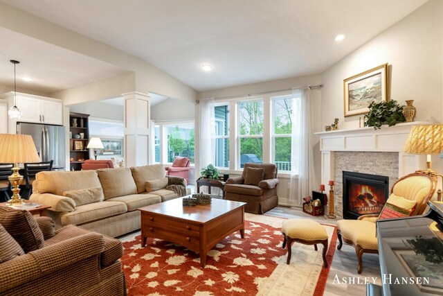 4700 Albright Ct SW Unit 6, Wyoming, MI 49418 - living room with a glass covered fireplace, light wood-style floors, ornate columns, and recessed lighting