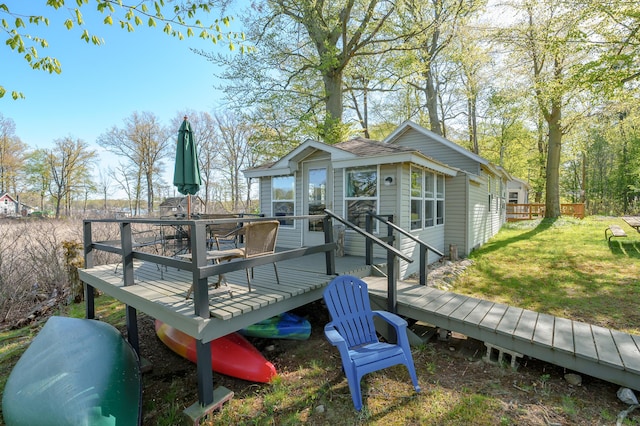 1098210976 Beech Is, Plainwell, MI 49080 - deck with a lawn and outdoor dining area