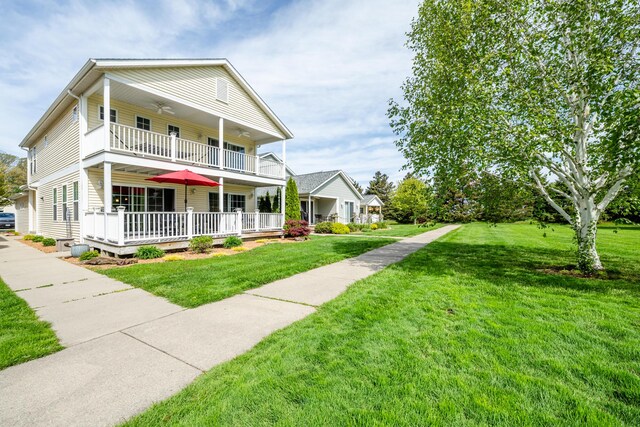 405 Anchors Way, Saint Joseph, MI 49085 - traditional-style home with a balcony, a front yard, a ceiling fan, and covered porch