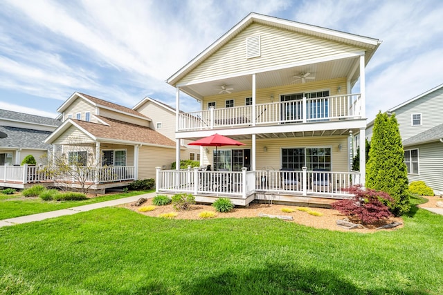 405 Anchors Way, Saint Joseph, MI 49085 - view of front of home featuring a balcony, a ceiling fan, a front yard, and covered porch