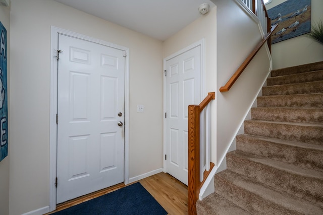 405 Anchors Way, Saint Joseph, MI 49085 - entryway with wood finished floors, stairway, and baseboards