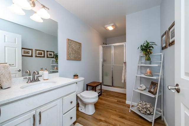 405 Anchors Way, Saint Joseph, MI 49085 - bathroom with wood finished floors, a shower stall, toilet, and vanity