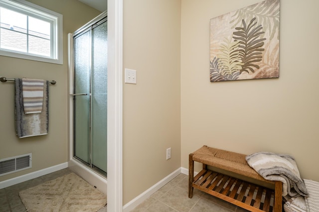405 Anchors Way, Saint Joseph, MI 49085 - bathroom with a shower with door, baseboards, and tile patterned floors