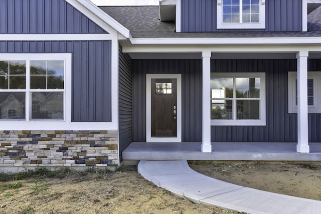 9423 Shoreway Dr, West Olive, MI 49460 - doorway to property featuring a porch, board and batten siding, and roof with shingles
